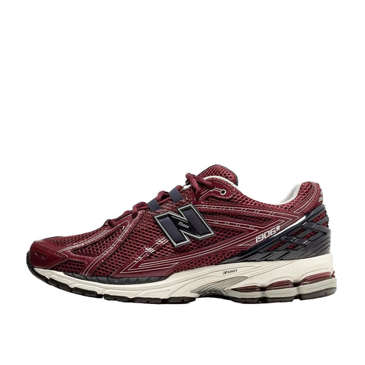 New Balance 1906R Burgundy Black sneakers, side view, model M1906RCC in burgundy with black highlights.