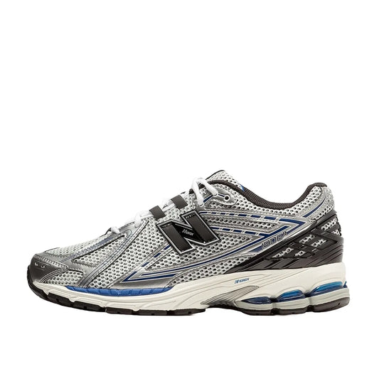 New Balance 1906R Metallic Silver Blue sneakers, side view, model M1906RCD in metallic silver with blue accents.