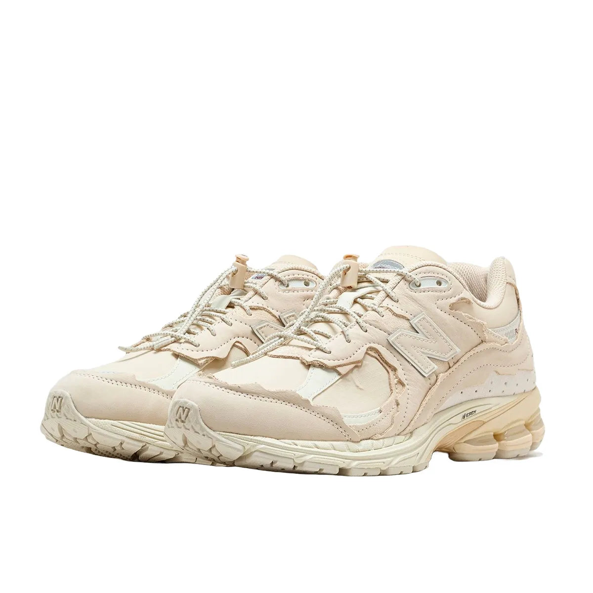 New Balance 2002R Protection Pack sneakers in Sandstone, front view, model M2002RDQ in beige.