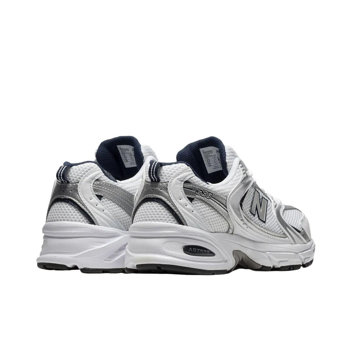 New Balance 530 sneakers, back view, model MR530SG, in white with silver and navy accents.