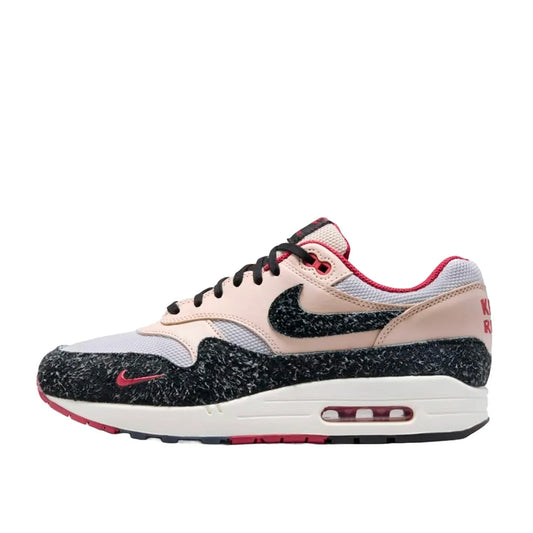 Nike Air Max 1 Keep Rippin Stop Slippin 2.0 sneakers, side view, model FD5743-200, black and beige with red accents.