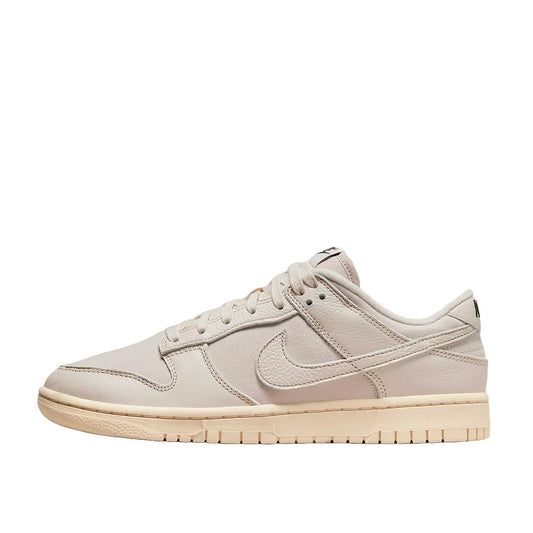 Nike Dunk Low Premium sneakers, side view, model DZ2538-100, in light orewood brown with white and beige accents.